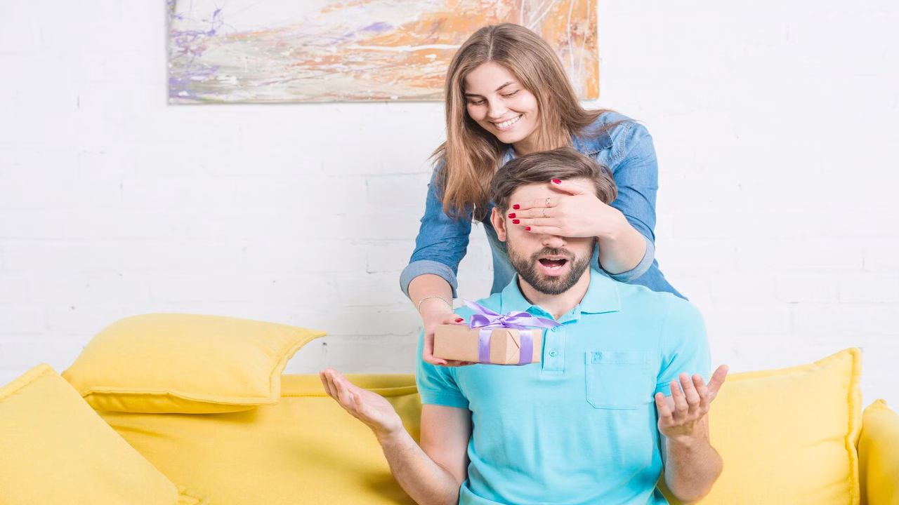 A wife giving her husband a thoughtful Father’s Day wish and card