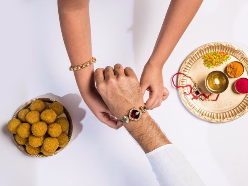 Raksha Bandhan Instagram post with siblings and festive background