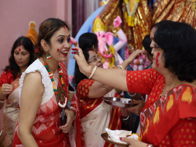 Employee wishing boss during festive office Dussehra celebration